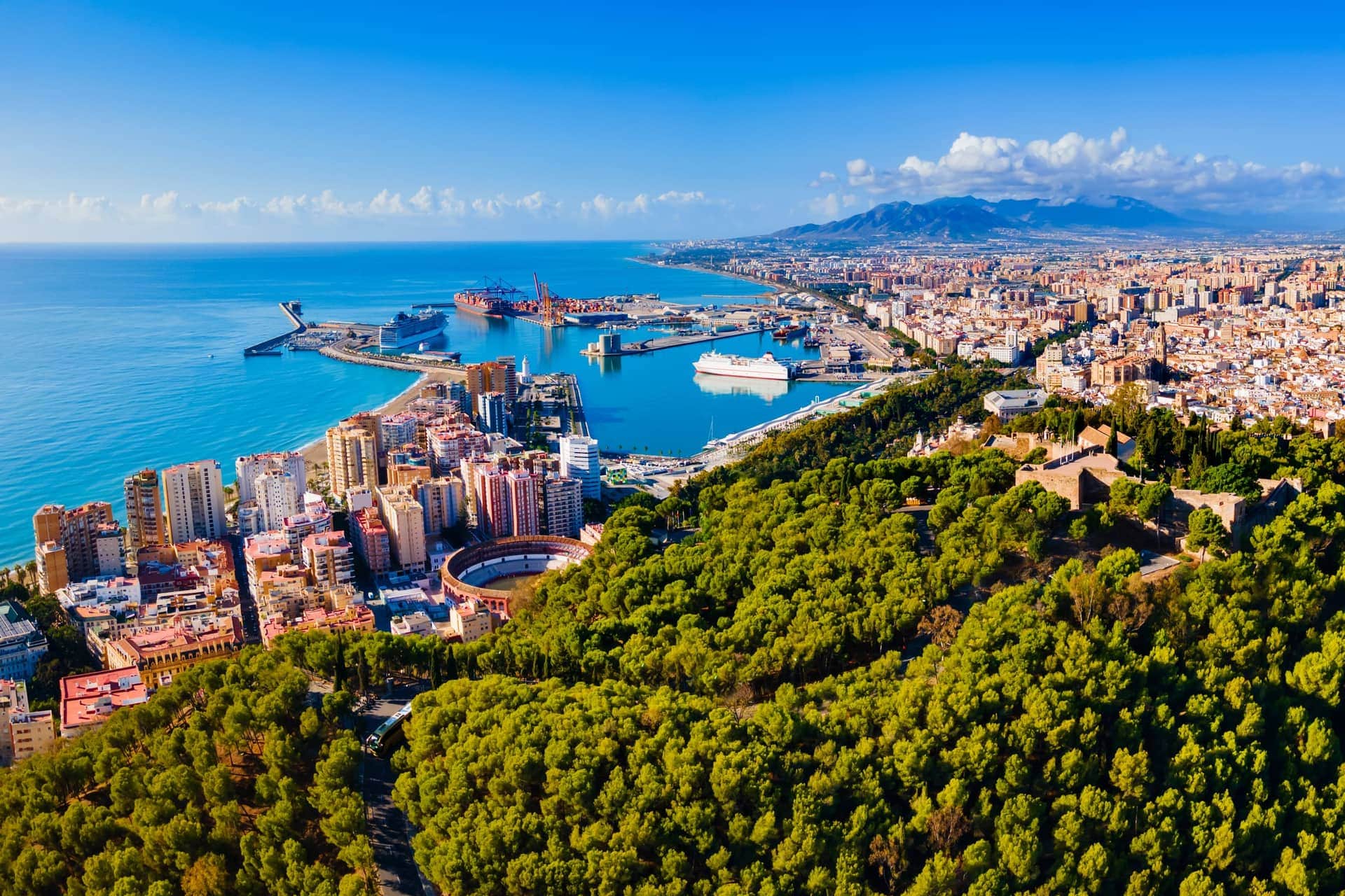 Aerial view of Málaga with the port and Gibralfaro Castle — AltaHomes boutique apartments